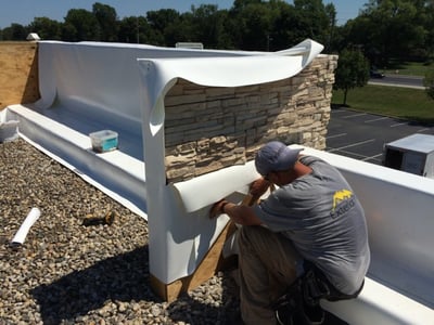 Crew_Member_working_on_Metal_Roof_Repair.jpg